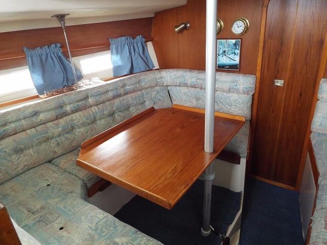 Cosy relaxing area, saloon portside.Note table has extension for sitters on starboard side.