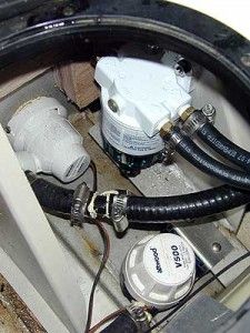 A tight fit, but it works. We located the filter head on a support knee. It can be reached for service through the access port in the splash well.