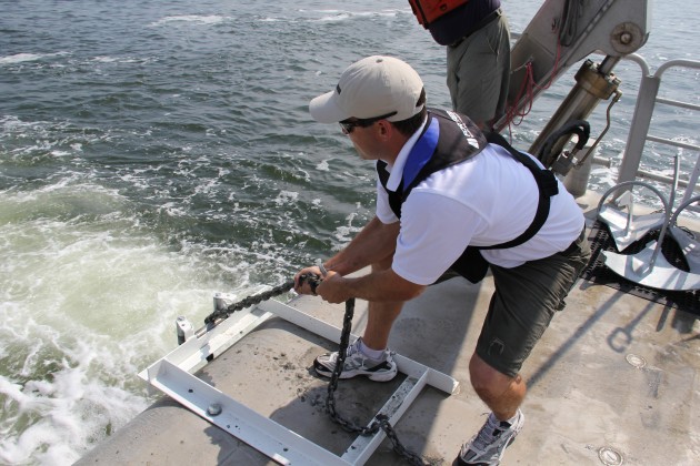 A Fortress Anchor representative hauls back an anchor during testing on the Chesapeake Bay. Photo courtesy of Fortress