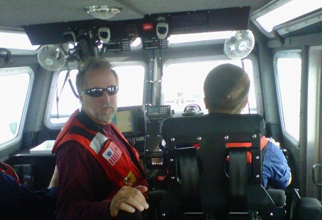 Tres Martin provides instruction on a U.S. Coast Guard rescue boat.