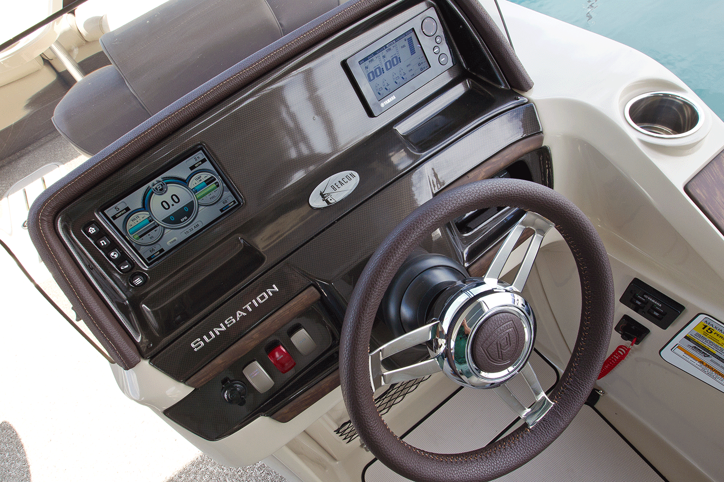This Premier pontoon boat has all of its systems integrated into an ind=dash touchscreen unit, one of many electronics options available on pontoon boats.