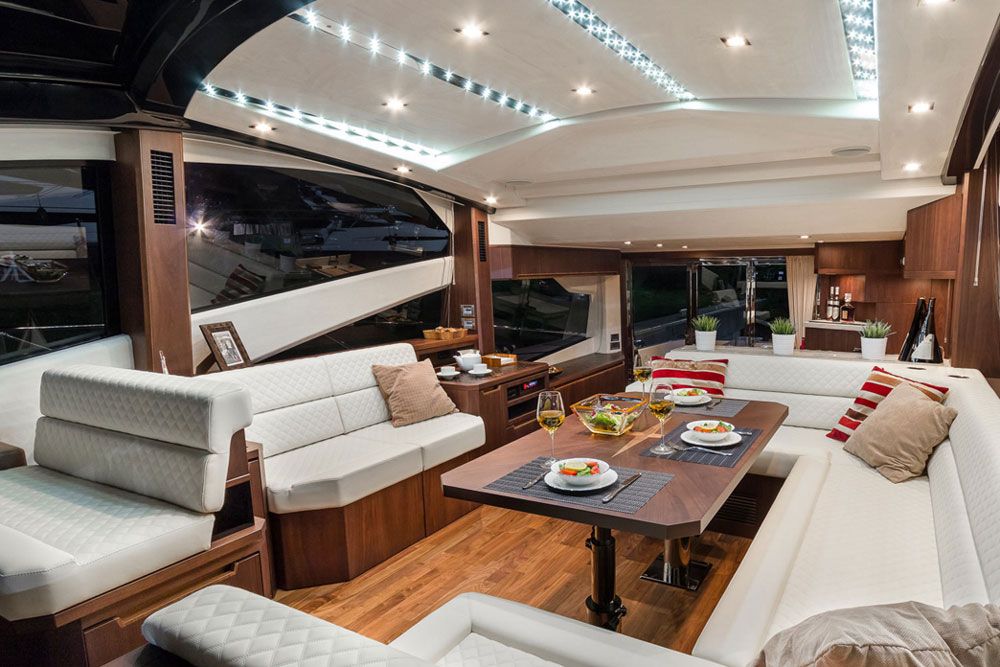 The main cabin of the Galeon 560 Skydeck shows excellent detailing. Note the unusual flooring, trim, and table woodwork.