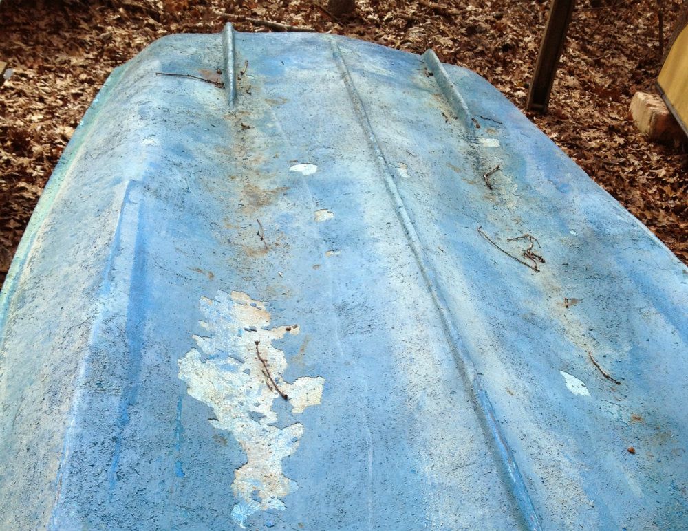 The bottom paint on this old Boston Whaler has to be completely stripped off, either by professional soda- or shell-blasting, or with a chemical stripper and putty knife. The first way is expensive, the second way tedious.