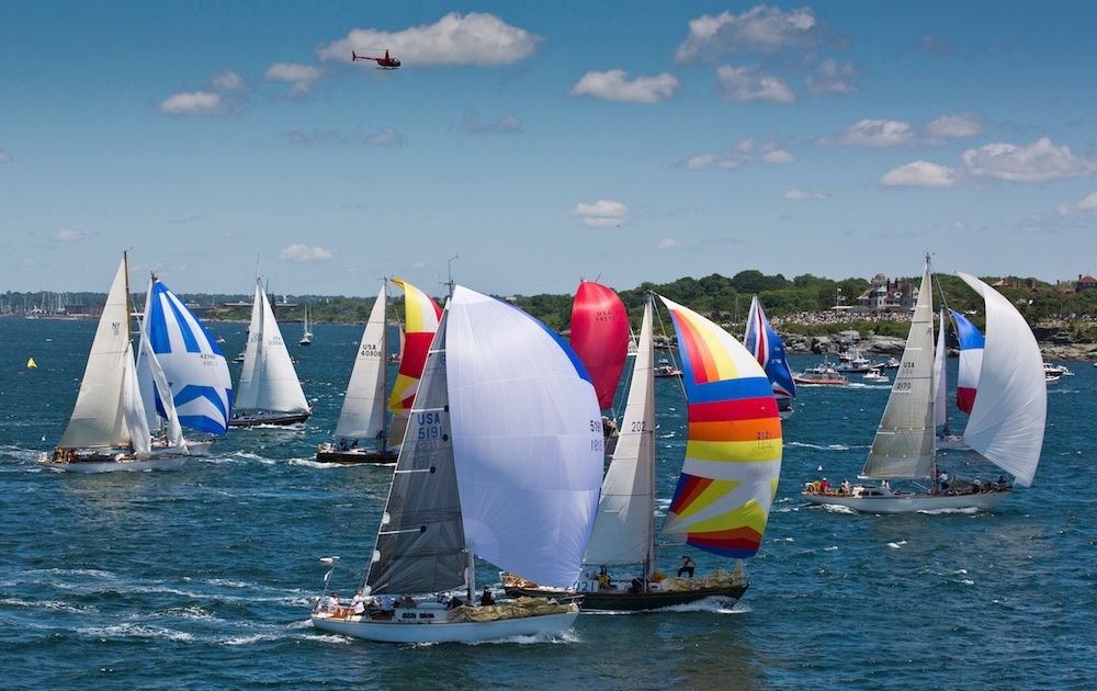 In a fresh northeasterly, with Newport landmarks Fort Adams and Inn at Castle Hill in the background, a class of 40-footers sets spinnakers and heads southeast toward Bermuda in June 2012. Photo: Daniel Forster/PPL