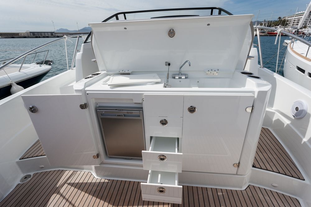 The outdoor galley has everything you need: a double sink, counter, the option of installing an electric grill, a refrigerator, and plenty of stowage. It’s slightly raised; a single step that improves the view from the helm as well as the headroom below deck.