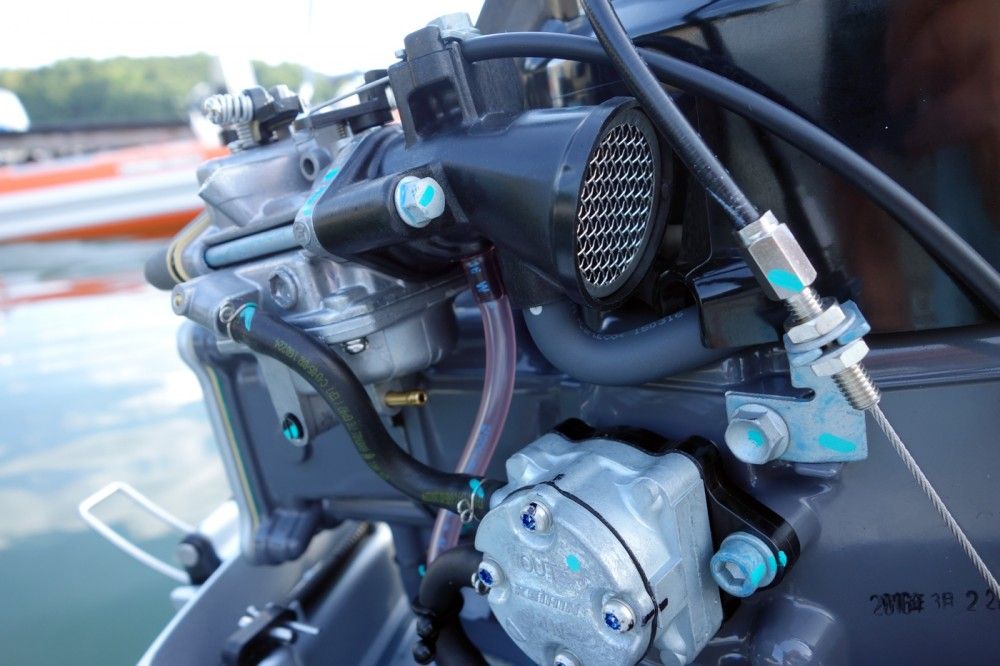 The fuel pump, filter (not visible) and carburetor are all easy to access. Attach a length of tubing to the small brass barb and back out a screw to neatly drain the float bowl for storage.