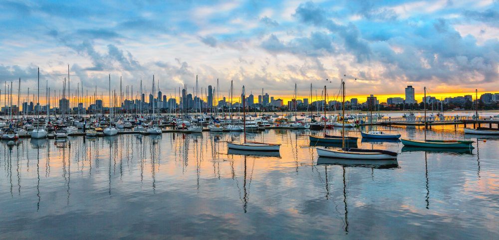 Sailboats moored at a city marina.