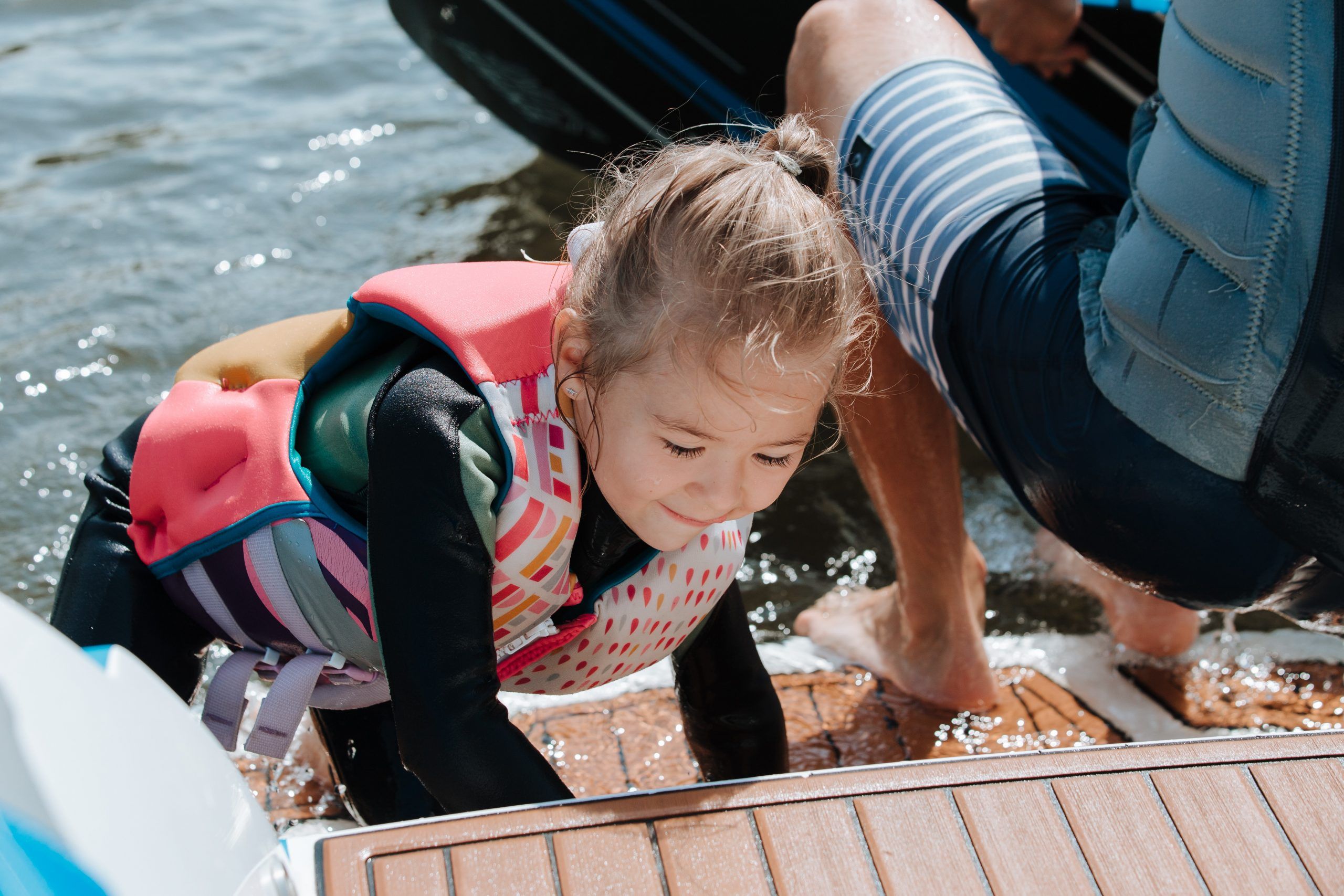 Family in life jackets gets ready for a day on the boat