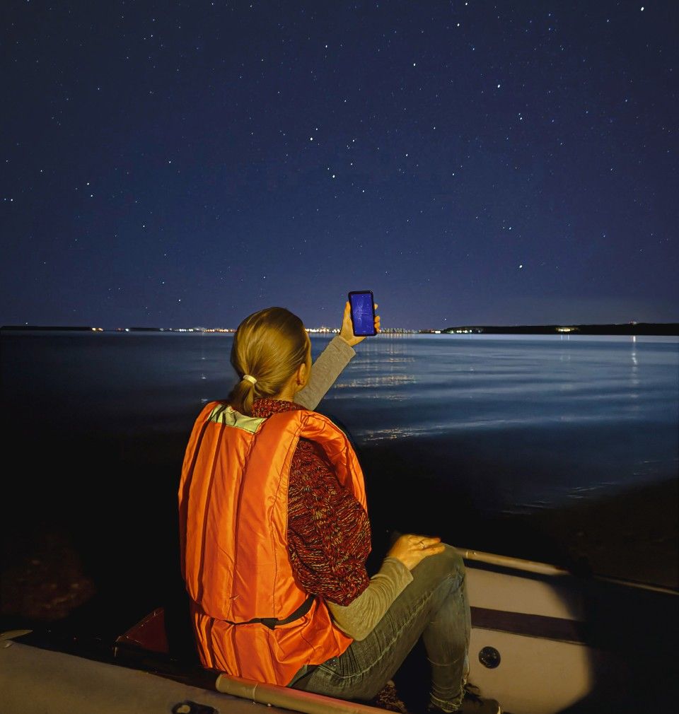 A lady stargazing on a boat