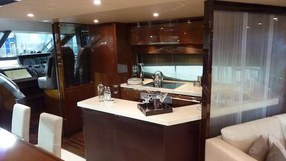 princess-72-motoryacht-9201 Amidships, the galley is just aft of the helm and immediately adjacent to the dining area.