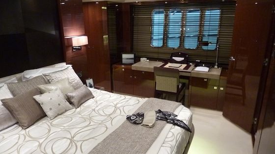 princess-72-motoryacht-9203 The master berth sits on centerline with writing desk to port and seating to starboard.