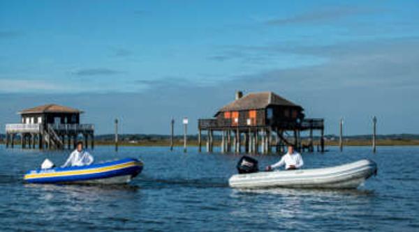 Zodiac Nomad RIB ALU 3.6 NEO Two Zodiac Nomad RIB ALU 3.6 NEO boats on water near stilt houses, 2024 model.