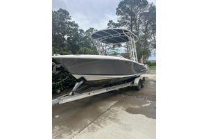 Chris-Craft Catalina 23 2016 Chris-Craft Catalina 23 boat on trailer, parked outdoors with trees in background.
