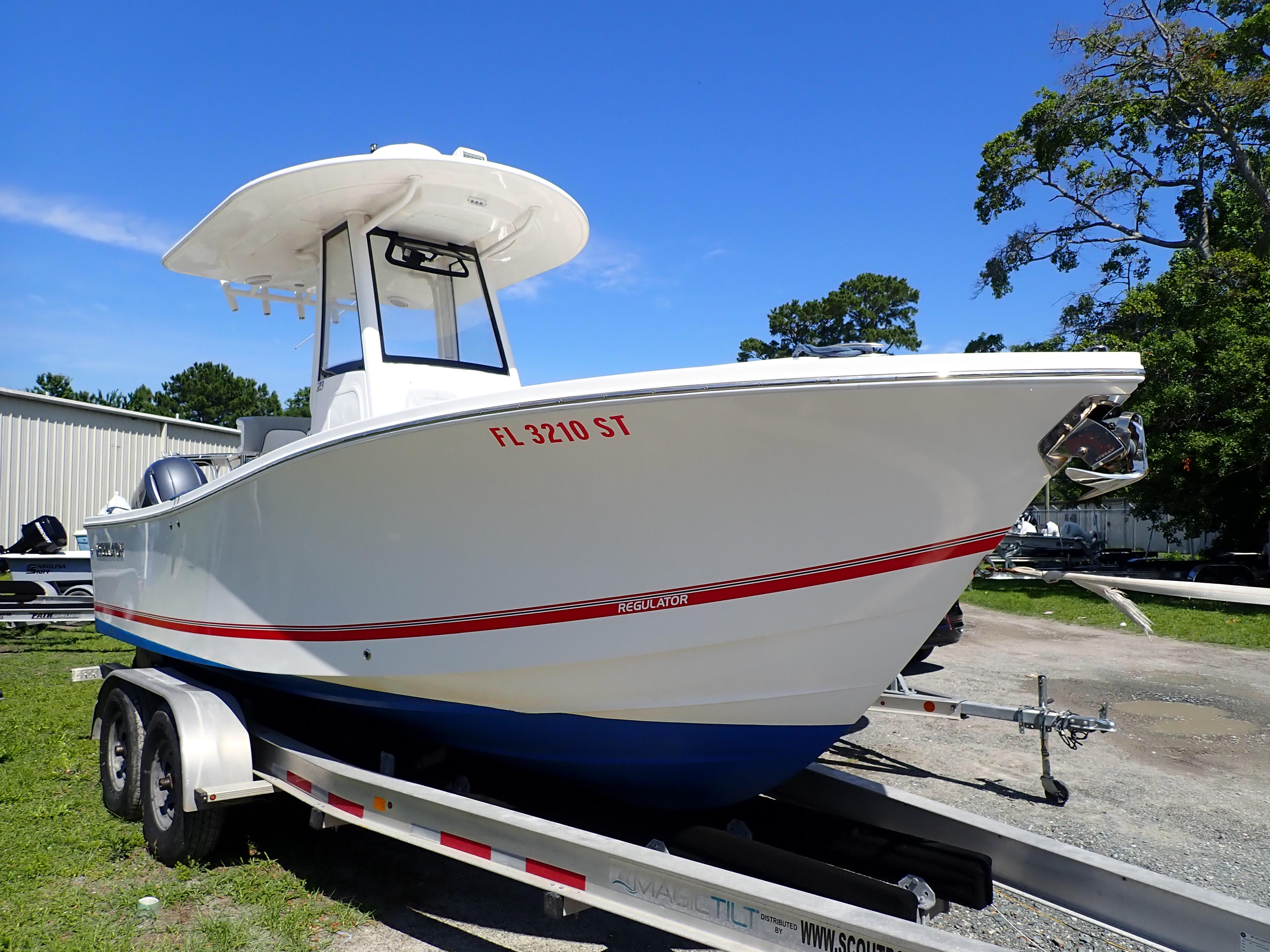 Regulator 23 Center Console 2020 Regulator 23 Center Console boat on trailer, parked outdoors.