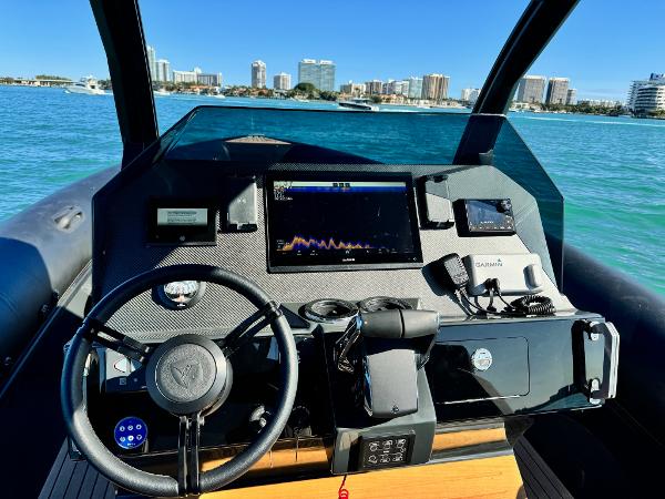 Skipper-BSK 34 Cockpit of 2025 Skipper-BSK 34 boat with modern navigation equipment, city skyline in background.