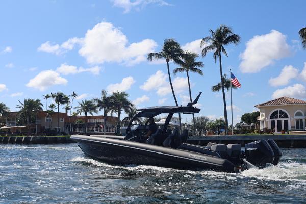 Skipper-BSK 34 2025 Skipper-BSK 34 boat cruising near palm trees and waterfront homes.