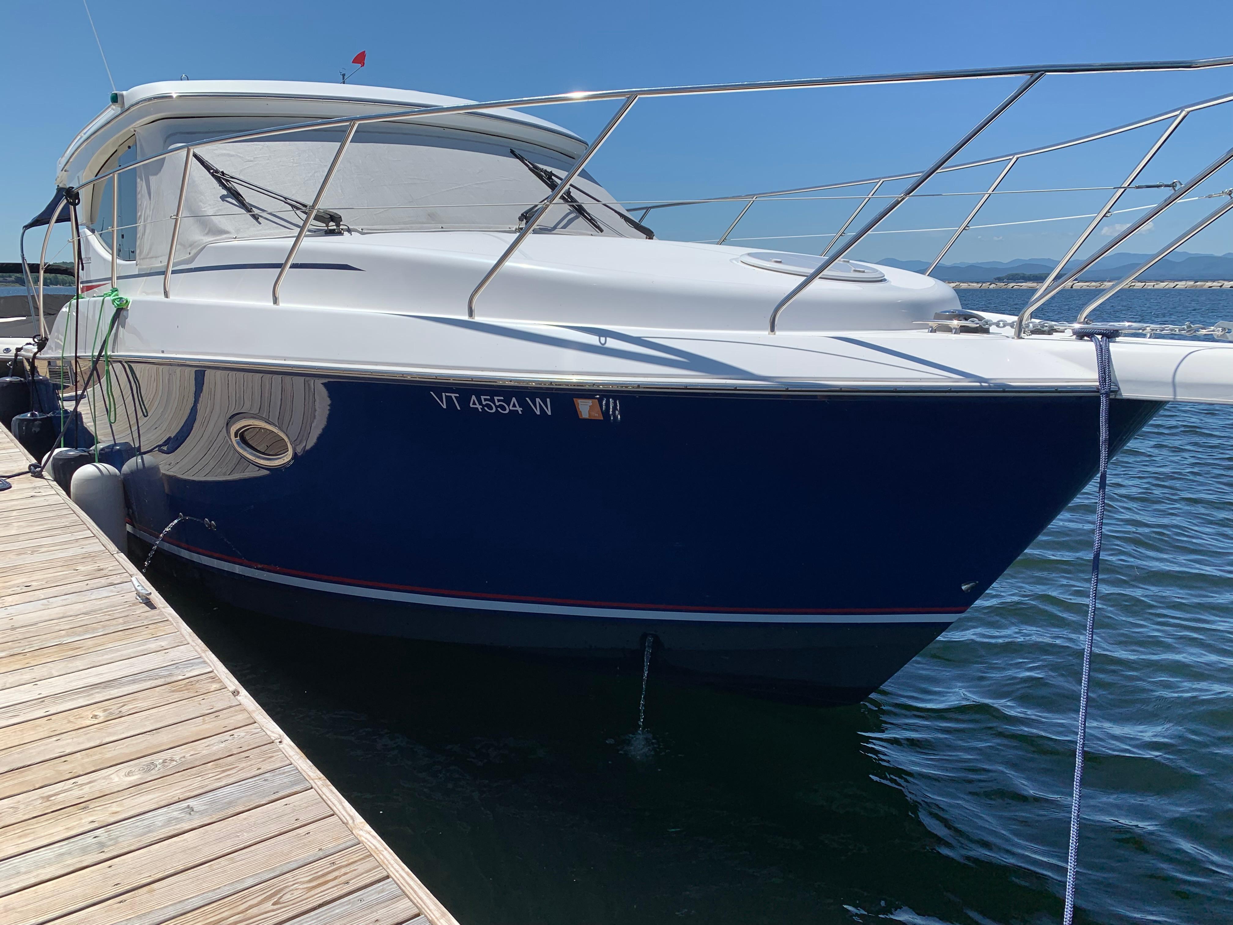 Silverton 33 Sport Coupe 2012 Silverton 33 Sport Coupe docked, featuring sleek design and blue hull.
