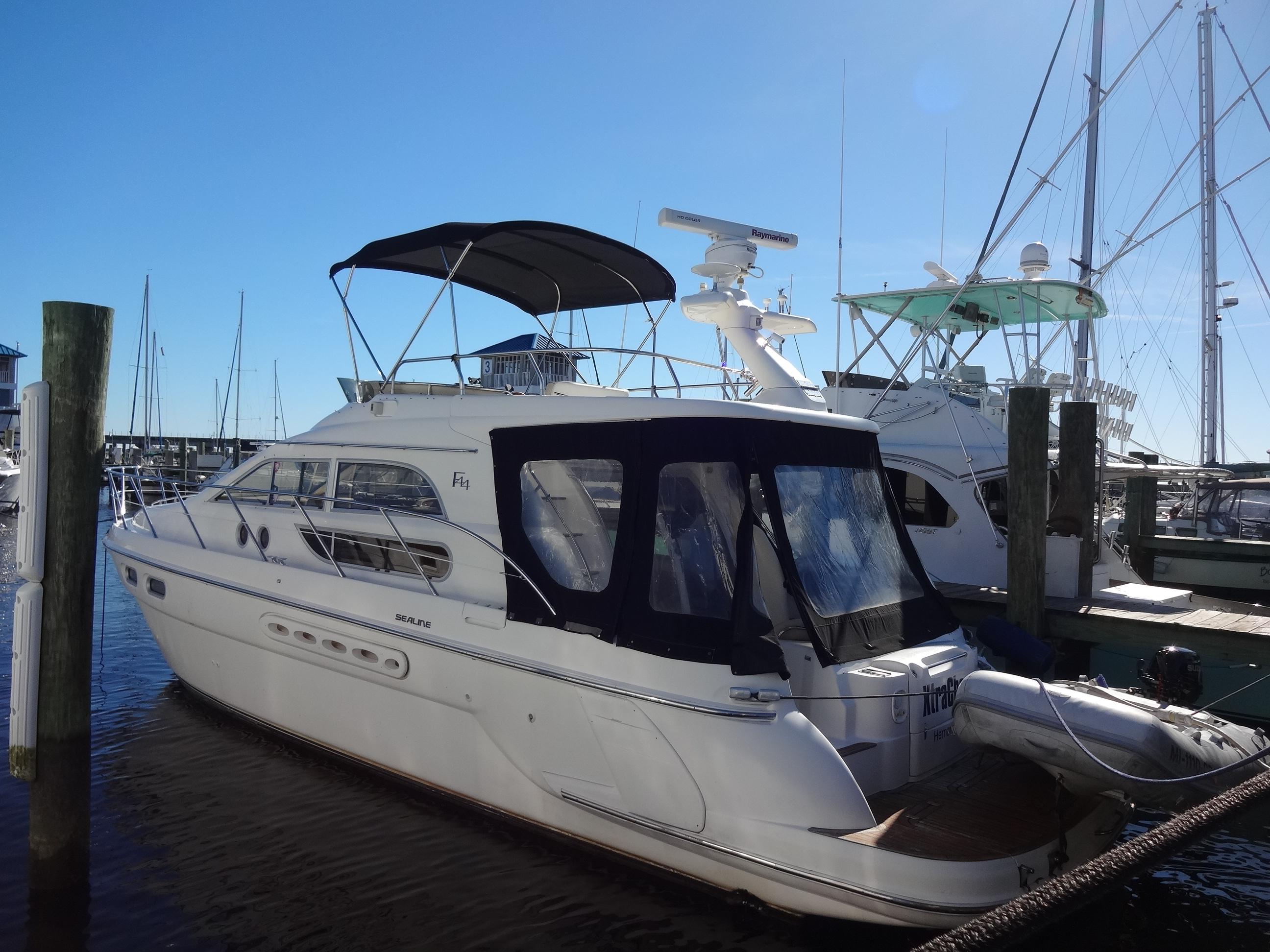 Sealine F44 1999 Sealine F44 yacht docked at marina under clear blue sky.