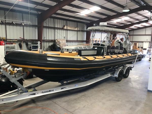 Ribcraft 9.0 2008 Ribcraft 9.0 boat on trailer in warehouse setting.