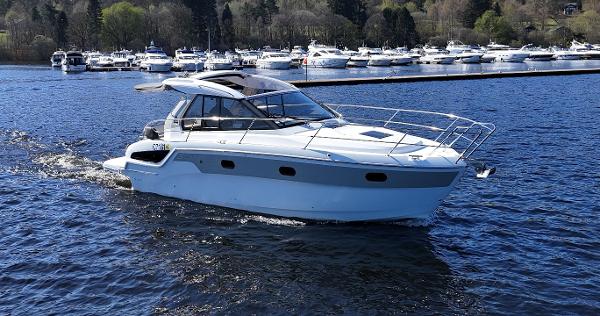 Bavaria S33HT 2021 Bavaria S33HT yacht cruising on a serene lake with other boats in the background.