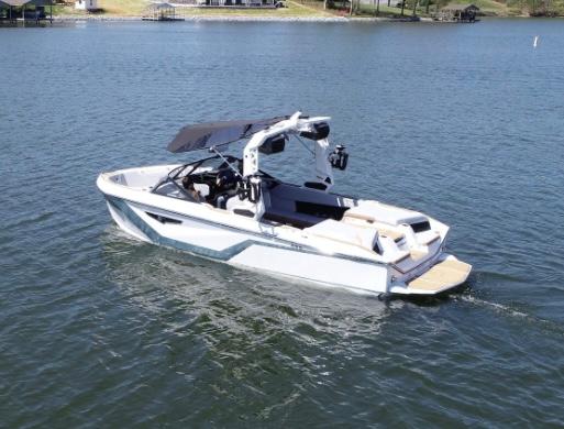 Nautique Super Air Nautique S23 2025 Nautique Super Air Nautique S23 boat on a serene lake.