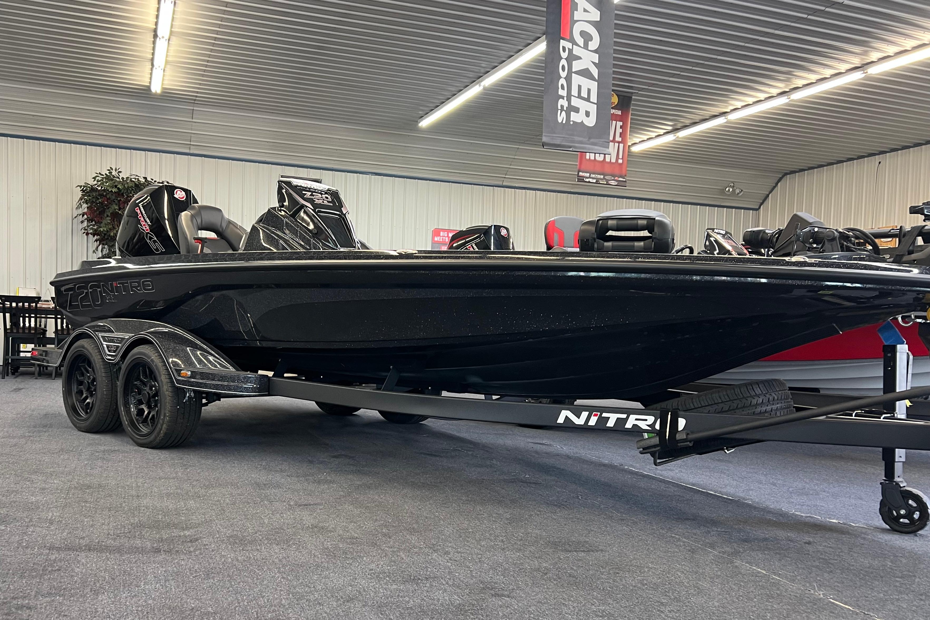 Nitro Z20 XL Pro 2026 Nitro Z20 XL Pro boat in showroom, sleek black design, dual axle trailer.