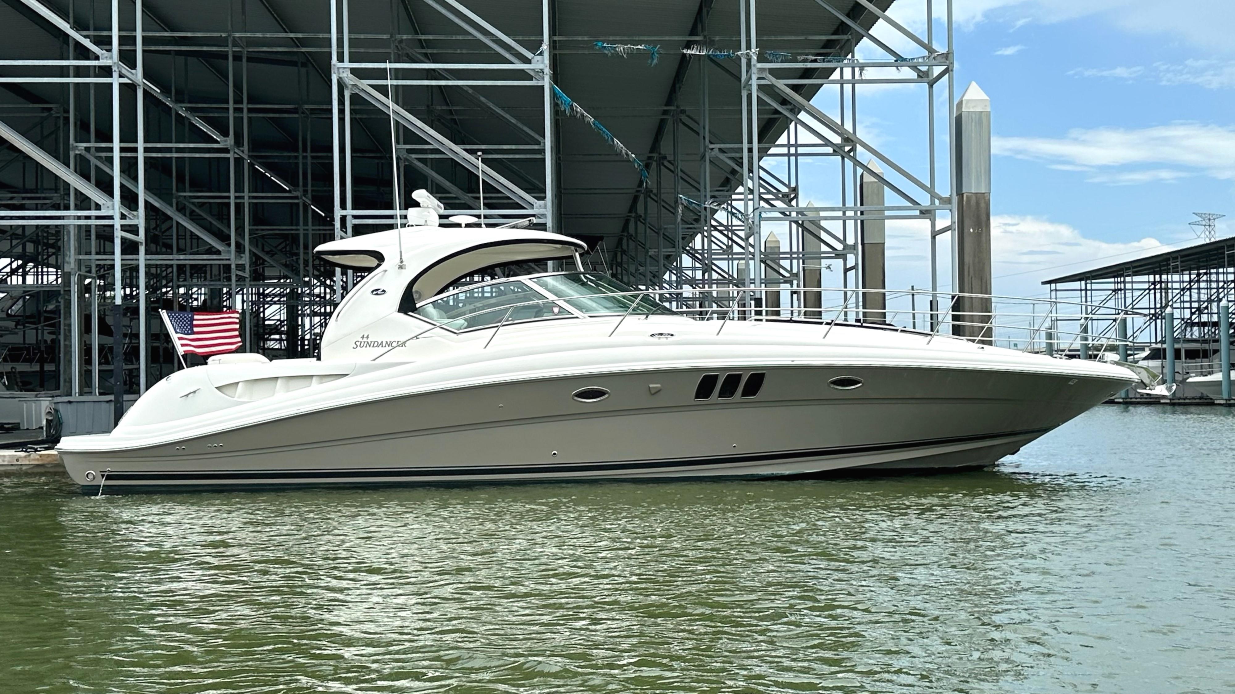 Sea Ray 44 Sundancer 2006 Sea Ray 44 Sundancer yacht docked at marina with American flag.