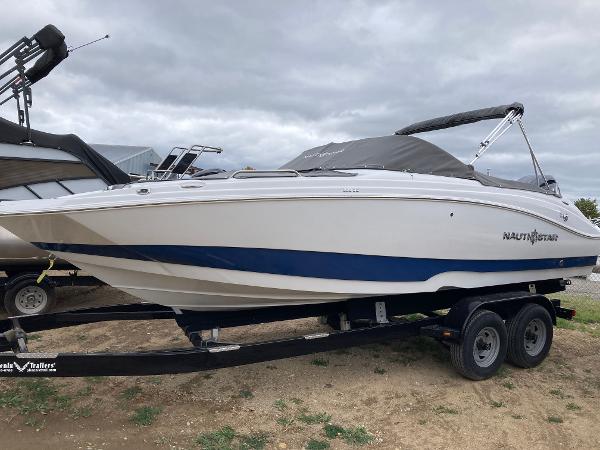 NauticStar 223 DC 2024 NauticStar 223 DC boat on trailer, side view.