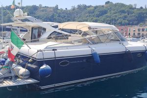 Itama ITAMA 48 2004 Itama ITAMA 48 yacht docked in a scenic marina with Italian flag.