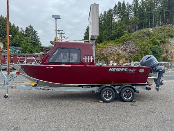 Hewescraft 200 ProV ET HT 2024 Hewescraft 200 ProV ET HT boat on trailer, red exterior, parked outdoors.