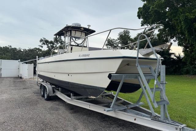 Sea Cat 255 1997 Sea Cat 255 boat on trailer, parked outdoors, ready for transport.