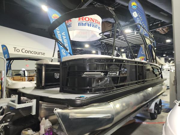 Godfrey AquaPatio Sundeck 255 SDC 2025 Godfrey AquaPatio Sundeck 255 SDC pontoon boat displayed at a marine exhibition.