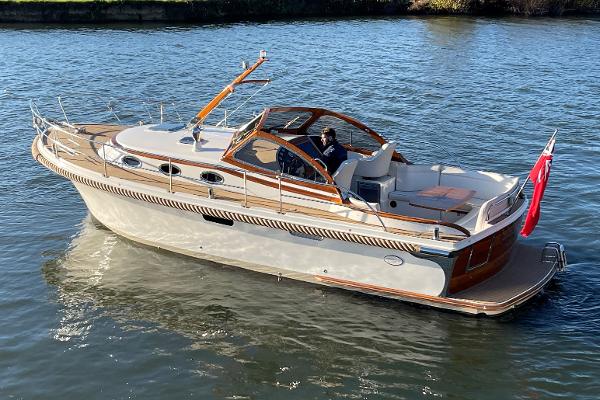 Intercruiser 34 2020 Intercruiser 34 boat cruising on a calm river.