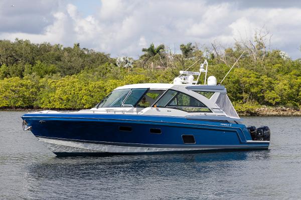Formula 430 Super Sport Crossover 2019 Formula 430 Super Sport Crossover boat on a calm lake.
