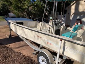Carolina Skiff 198 DLV 1997 Carolina Skiff 198 DLV boat on trailer, parked outdoors.
