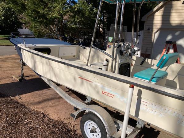 Carolina Skiff 198 DLV 1997 Carolina Skiff 198 DLV boat on trailer, parked outdoors.