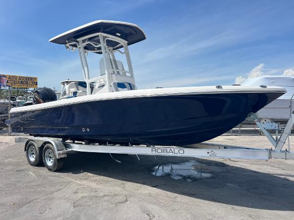 Robalo 226 Cayman 2025 Robalo 226 Cayman boat on trailer, blue hull, sunny day.