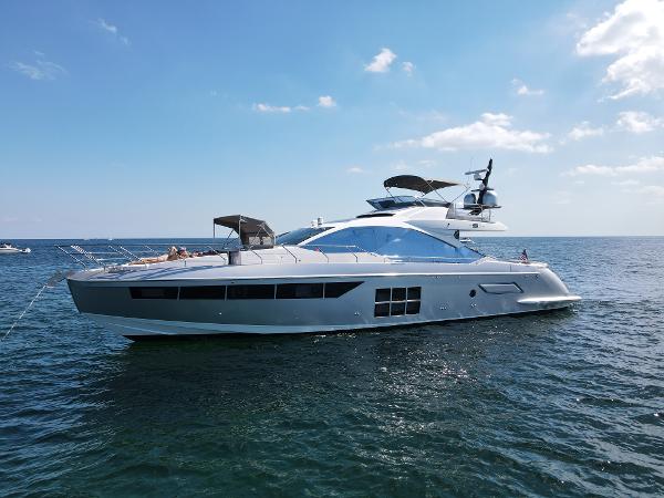 Azimut S7 Luxurious 2019 Azimut S7 yacht cruising on open water under a clear blue sky.