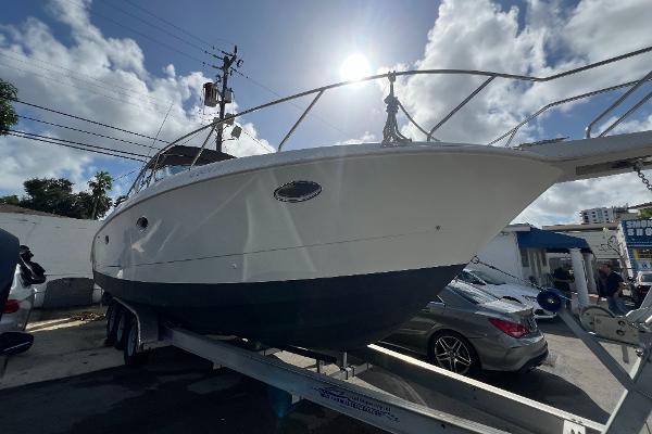 Silverton 310 Express 1996 Silverton 310 Express boat on trailer under sunny sky.