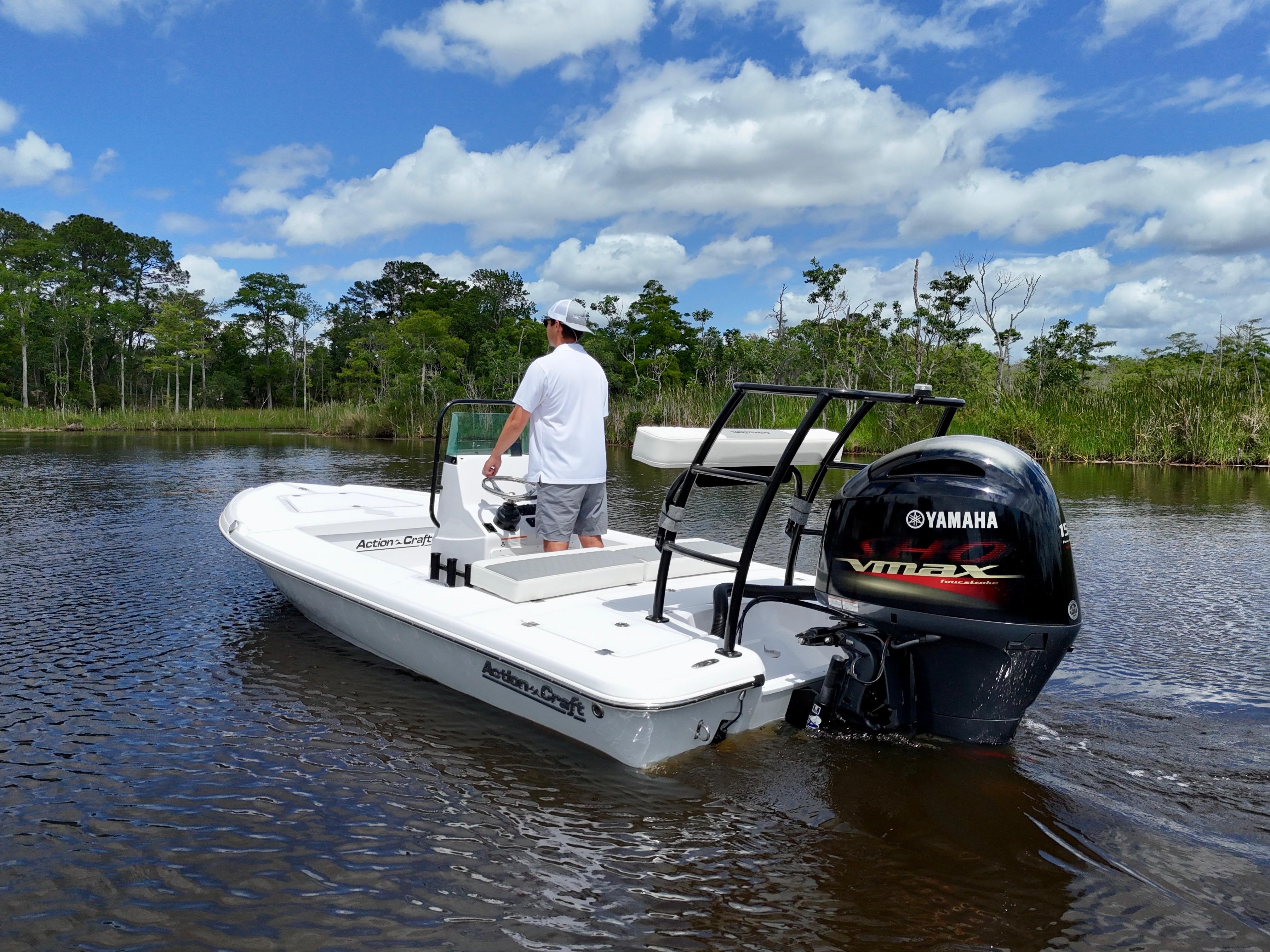 Action Craft 17 Flats 2025 Action Craft 17 Flats boat with Yamaha VMAX engine on a calm river.
