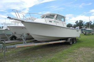 Parker 2520 Deep Vee Sport Cabin 2020 Parker 2520 Deep Vee Sport Cabin boat on trailer, parked on grass.