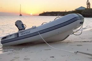 Highfield Ultralite 260LT 2025 Highfield Ultralite 260LT inflatable boat on sandy beach at sunset.