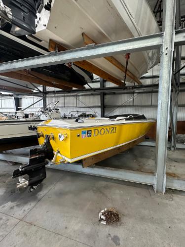 Donzi 22 Classic 1995 Donzi 22 Classic yellow speedboat in storage.
