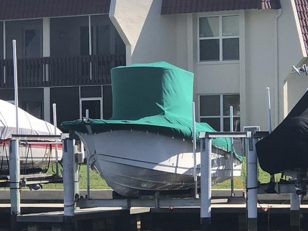 Trophy 2503 Center Console 2004 Trophy 2503 Center Console boat covered, docked near waterfront buildings.