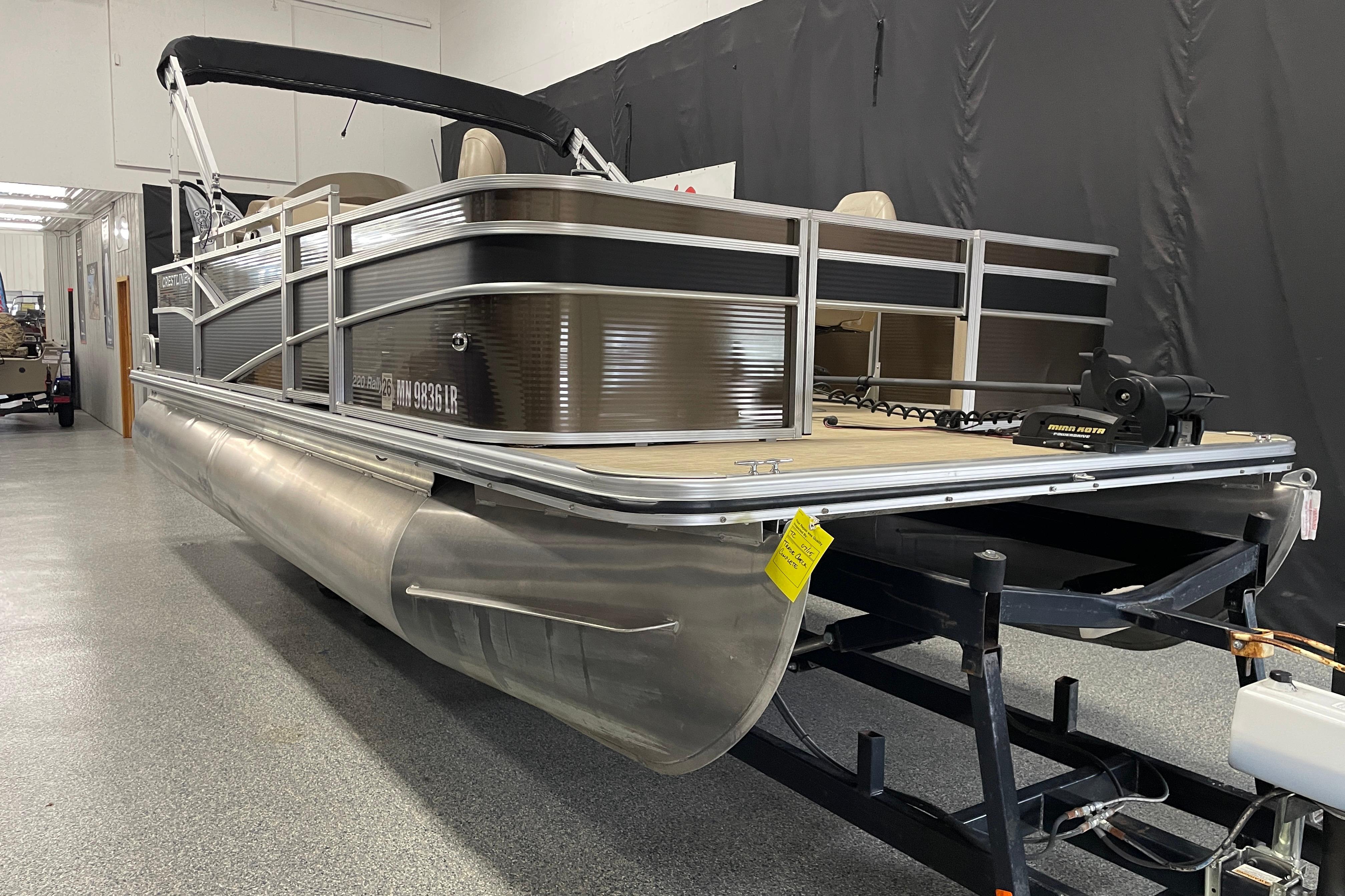 Crestliner FS 220 2018 Crestliner FS 220 pontoon boat in showroom, featuring sleek aluminum design.