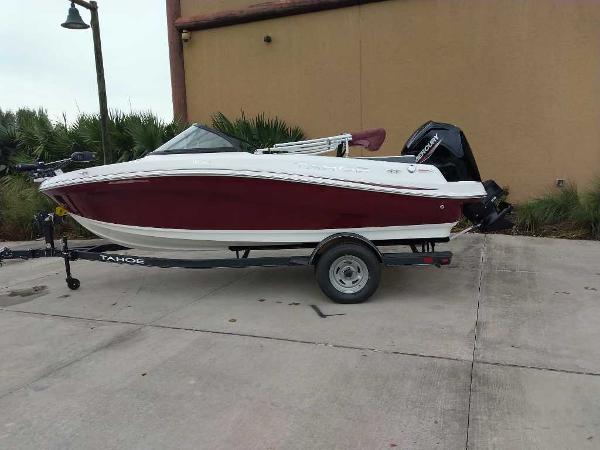 Tahoe 185 S 2024 Tahoe 185 S boat on trailer, red and white design, parked outdoors.