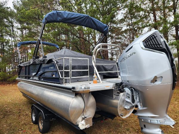 Godfrey Monaco 255 SFL 2025 Godfrey Monaco 255 SFL pontoon boat with Honda outboard motor, parked on trailer.