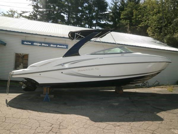 Rinker 246 Bowrider 2015 Rinker 246 Bowrider boat on display outside a sales and rental shop.