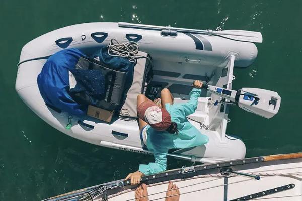 Highfield Ultralite 240LT 2024 Highfield Ultralite 240LT inflatable boat with person and gear on water.