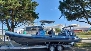 Highfield Sport 700 JO 2024 2024 Highfield Sport 700 JO boat on trailer, parked near trees and industrial buildings.